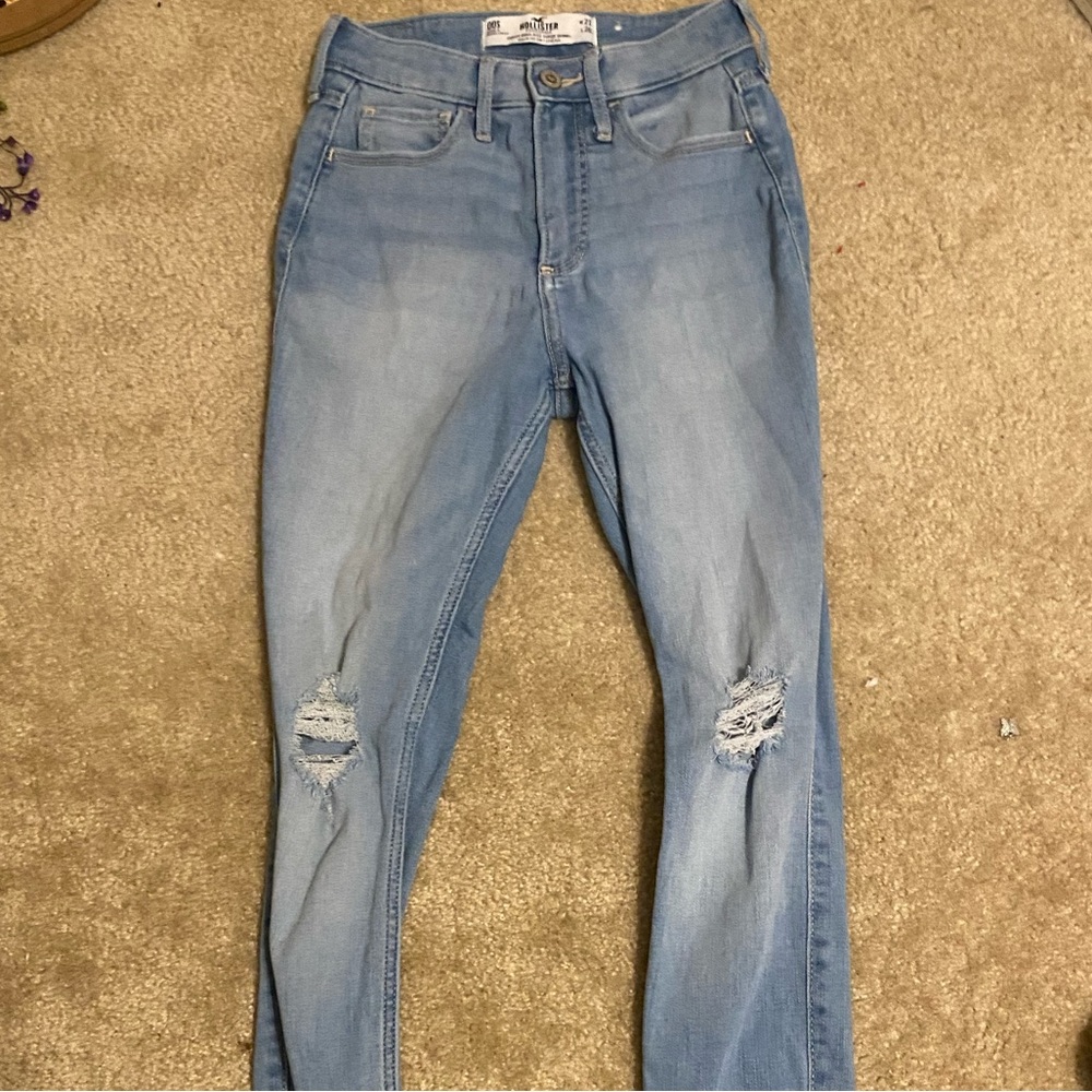 Light blue jeans, with holes in the knee